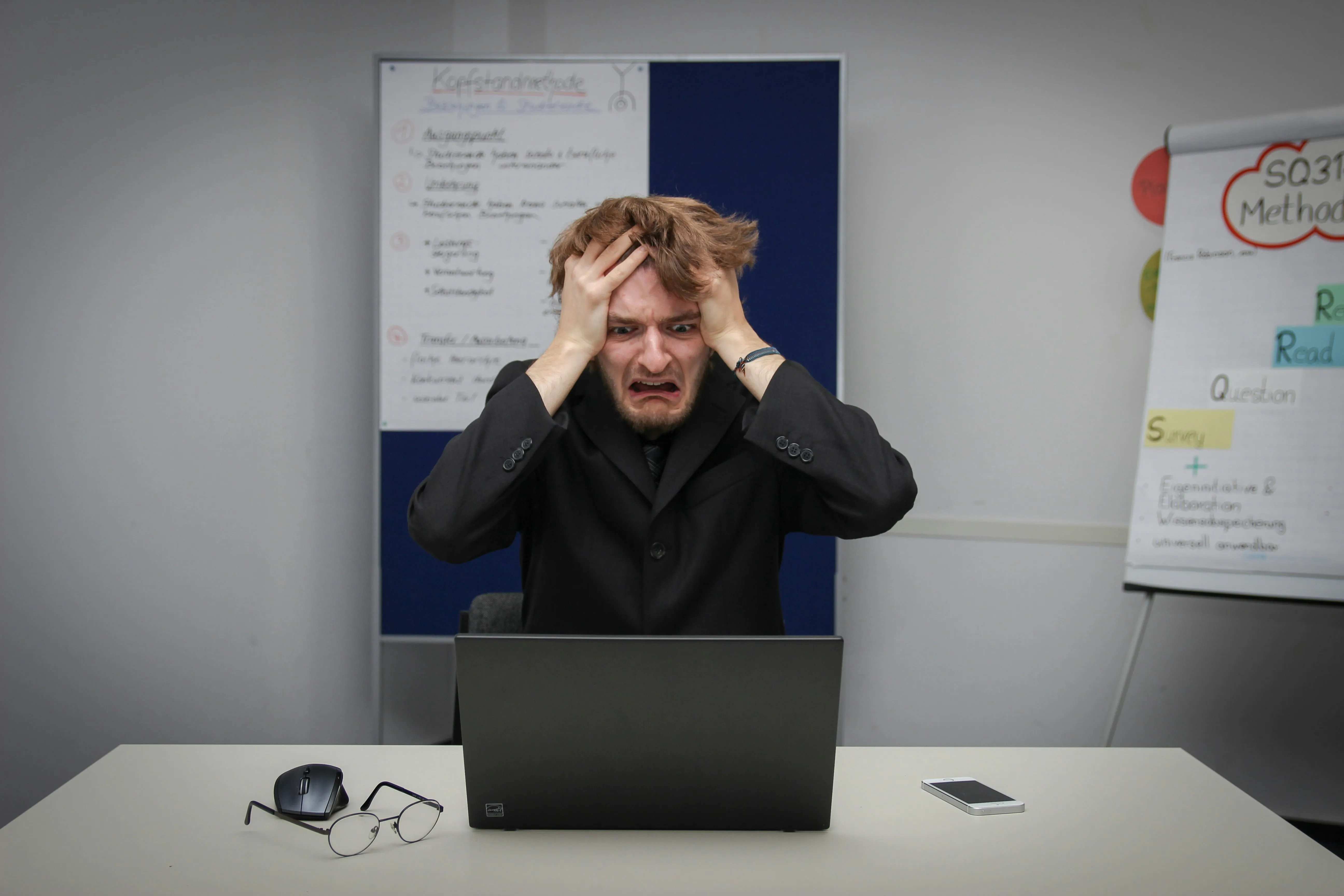 A stressed-out exec sitting at a cluttered desk
